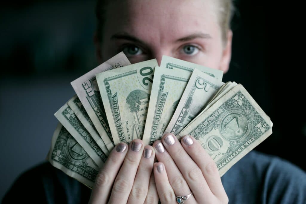Woman holding US Dollars
