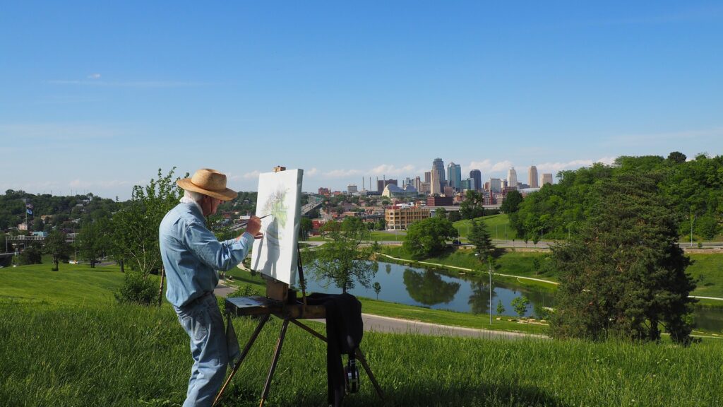 Older person painting outside